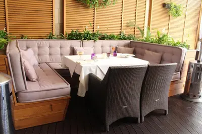 a table and chairs with a table and a couch at Casa Boyana Boutique Hotel in Sofia