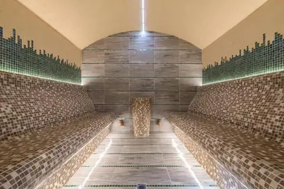 a row of benches in a room with tiles at Lion Bansko Hotel in Bansko
