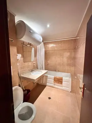 a bathroom with a toilet and a sink and a tub at Mountain Paradise 2, One bedroom apartment in Bansko