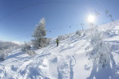 a person skiing down a snow covered ski slope at Mountain Paradise 2, One bedroom apartment in Bansko