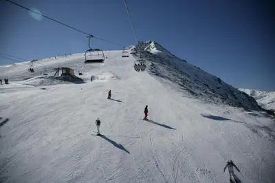 a group of people skiing down a ski slope at Mountain Paradise 2, One bedroom apartment in Bansko