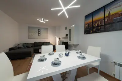 a white table and chairs in a living room at Grand Vitosha Apartments in Sofia