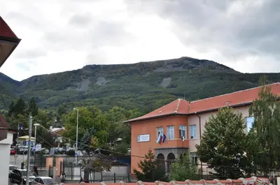 a building with a mountain in the background at Family Hotel Bansko Sofia in Sofia