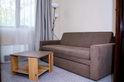 a living room with a couch and a coffee table at Hotel Orphey in Bansko