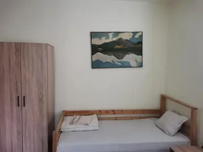 a bedroom with two beds and a picture on the wall at Guesthouse Tzar Asen in Sofia
