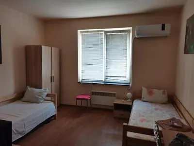 a small room with two beds and a window at Guesthouse Tzar Asen in Sofia