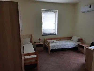 a room with two beds and a window at Guesthouse Tzar Asen in Sofia