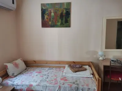 a bedroom with a bed and a painting on the wall at Guesthouse Tzar Asen in Sofia