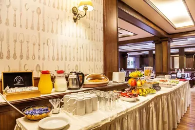 a long table with food on it in a restaurant at Chateau Montagne Hotel Troyan in Troyan