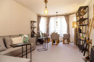 a living room with a couch and tables and chairs at Villa Sokol in Borovets