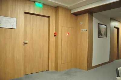 a hallway with two wooden doors in a building at Legends Hotel in Sofia