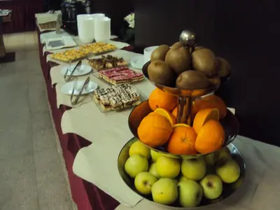 a table with a display of fruit and other foods at Gardenia Park Hotel in Bansko