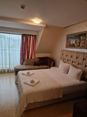 a bedroom with a bed with two towels on it at Hotel Gabi in Plovdiv