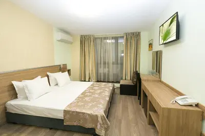a hotel room with a bed and a telephone at Hotel Gabi in Plovdiv