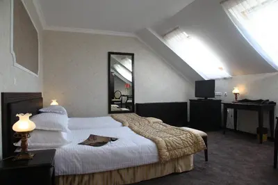 a hotel room with a large bed and a mirror at Strimon Garden Medical SPA Hotel in Kyustendil
