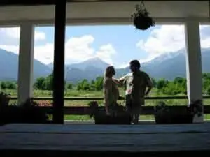 a man and a woman standing in front of a window at Rahoff hotel in Bansko
