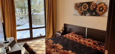 a bedroom with a bed and a large window at TERRA COMPLEX D4 - Private apartment - Golf, Skiing & SPA in Bansko