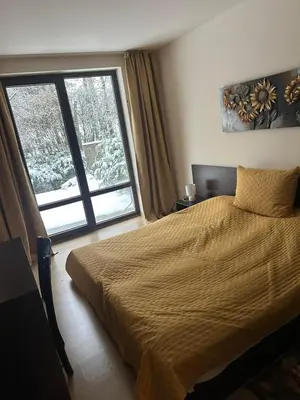 a bedroom with a bed and a large window at TERRA COMPLEX D4 - Private apartment - Golf, Skiing & SPA in Bansko