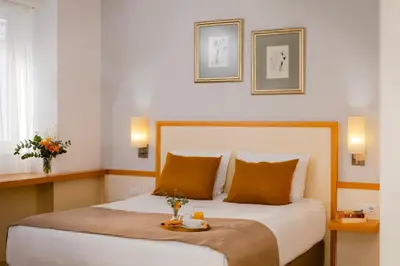 a hotel room with a bed with a tray on it at Arte Sofia Hotel in Sofia