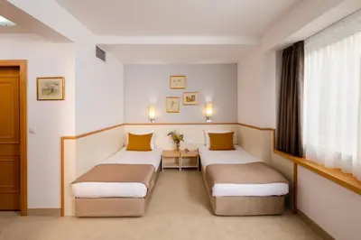 a hotel room with two beds and a window at Arte Sofia Hotel in Sofia