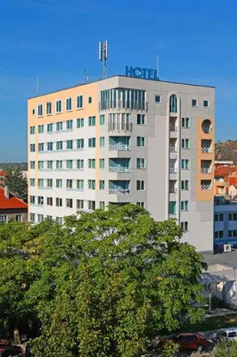 a hotel building with a sign on top of it at Hotel Rila in Dupnitsa