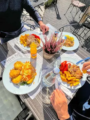 a table with plates of food on top of it at Hotel Rila in Dupnitsa
