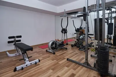 a gym with several exercise equipment in a room at Mountain Paradise next to Sunrise in Bansko