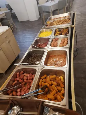 a buffet line with many trays of different foods at Mountain Paradise next to Sunrise in Bansko