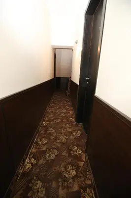 a corridor with a tile floor in a hallway at Hotel & Restaurant The House in Sofia