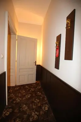 a room with a white door and a room with a carpet at Hotel & Restaurant The House in Sofia