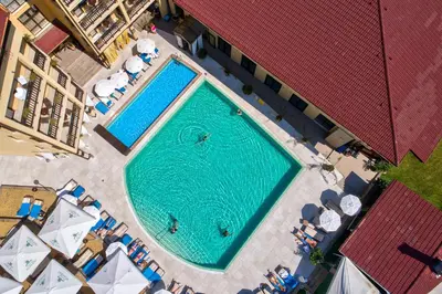 an overhead view of a swimming pool with chairs and umbrellas at Grand Hotel Velingrad in Velingrad