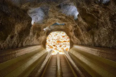 an escalator in a cave with a brick wall at Grand Hotel Velingrad in Velingrad