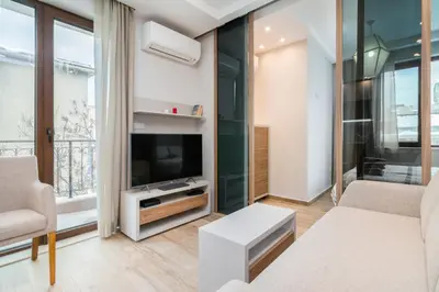 a living room with a couch and a tv at M&M Modern & Multifunctional One Bedroom Apartment by Flat Mаnager in Sofia