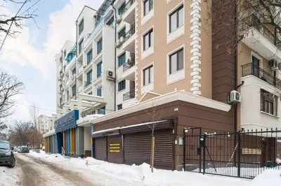 a building on a street with snow on the ground at M&M Modern & Multifunctional One Bedroom Apartment by Flat Mаnager in Sofia