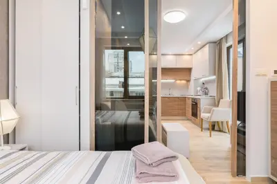 a bedroom with a king sized bed and a kitchen at M&M Modern & Multifunctional One Bedroom Apartment by Flat Mаnager in Sofia