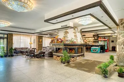 a lobby with a fireplace in a store at Hotel Bansko SPA & Holidays - Free Parking in Bansko