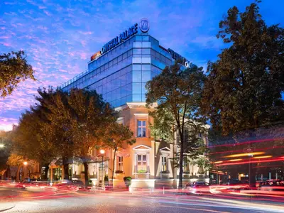 a building with a clock on the top of it at Crystal Palace Boutique Hotel in Sofia