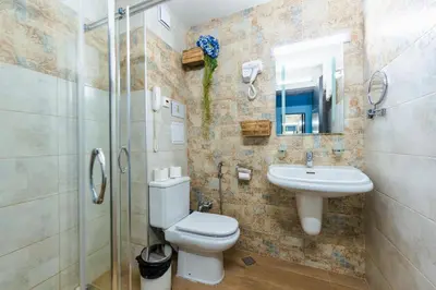 a bathroom with a toilet and a sink and a shower at Wellness Hotel Bulgaria in Bansko