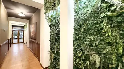 a hallway with a green wall in a house at Platinum Hotel and Casino Bansko in Bansko