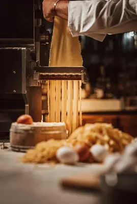 a person is making food on a table at Katarino SPA Hotel in Bansko