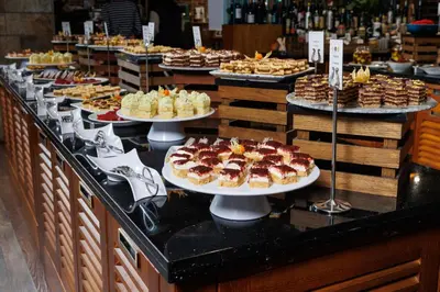 a buffet line with plates of desserts and pastries at Katarino SPA Hotel in Bansko