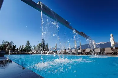 a fountain in the middle of a swimming pool at Katarino SPA Hotel in Bansko