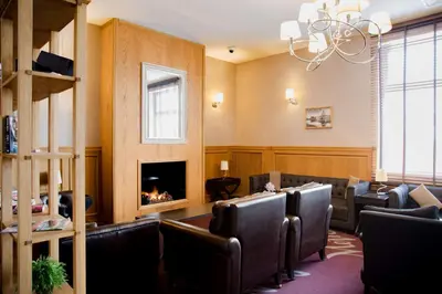 a waiting room with leather chairs and a fireplace at Metropolitan Hotel Sofia, a member of Radisson Individuals in Sofia