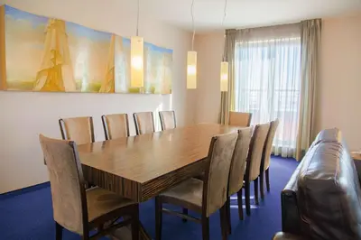 a dining room with a wooden table and chairs at Metropolitan Hotel Sofia, a member of Radisson Individuals in Sofia