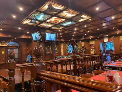 a restaurant with tables and chairs and televisions at Alpin Borovets, Алпин Боровец in Borovets