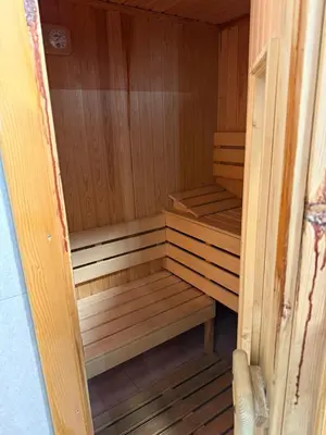 a wooden sauna with wooden benches in a room at Alpin Borovets, Алпин Боровец in Borovets