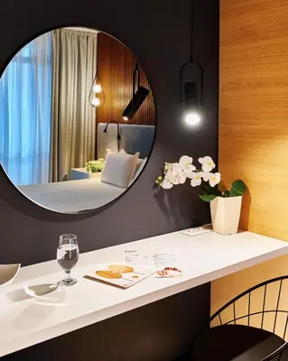 a room with a table and a mirror at Lucky Bansko Aparthotel SPA & Relax in Bansko