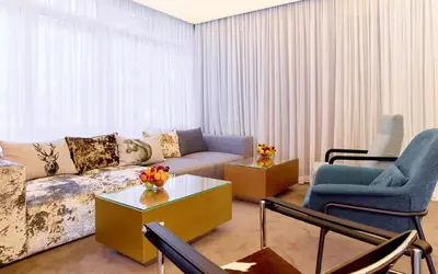 a living room with a couch and two chairs at Lucky Bansko Aparthotel SPA & Relax in Bansko