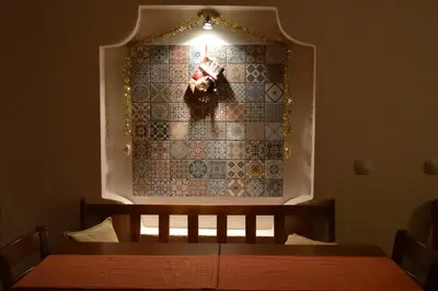 a room with a bed with a light on a wall at Horizont Dobrinishte in Dobrinishte