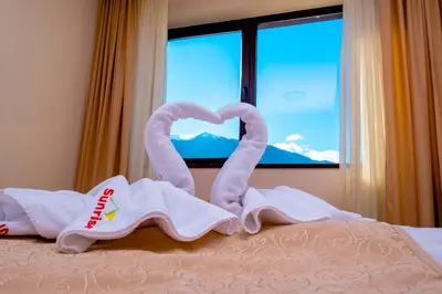 a bed with towels in the shape of a heart at Sunrise Park Hotel Bansko - Free Wellness in Bansko